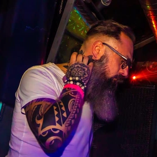 A DJ listening on headphones
